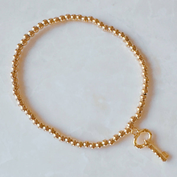 Golden Ball Single Charm Stretch Bracelet: Simply Cross